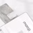 A business card with the text 'mocp' and 'Personal Brand' is placed on a rectangular concrete block. Below it, a tablet or large device displays 'mocp' in bold lettering and some text and QR codes. The setup is arranged on a white background with soft shadows.